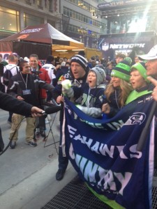 A Seattle family is coached to cheer for the Seahawks by the local Channel 7 crew.